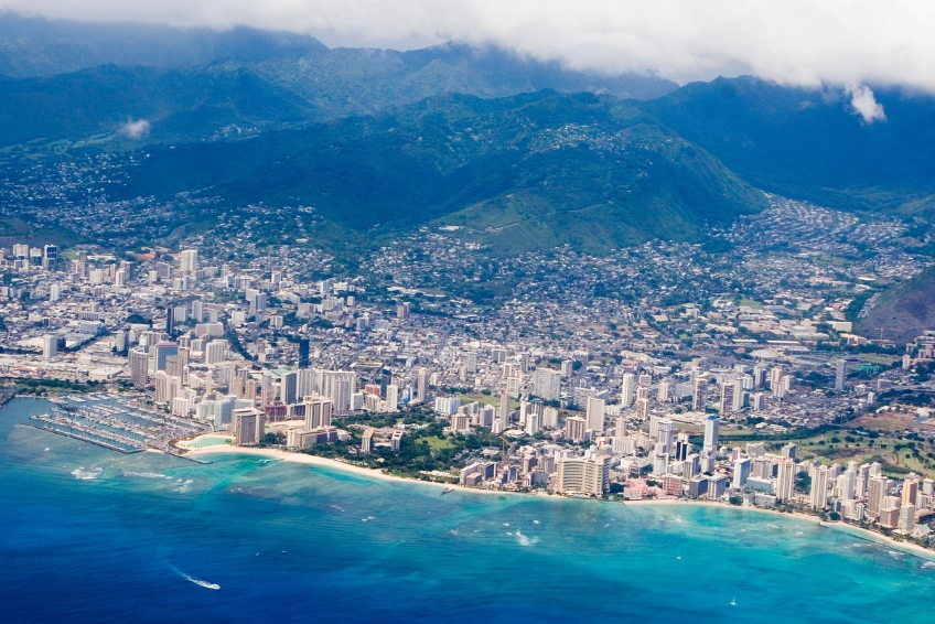 Aerial view of Honolulu, Hawaii showing Waikiki Beach, skyline, marina, and turquoise Pacific Ocean waters
